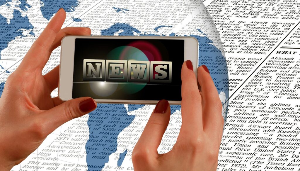 Hands holding mobile phone saying news