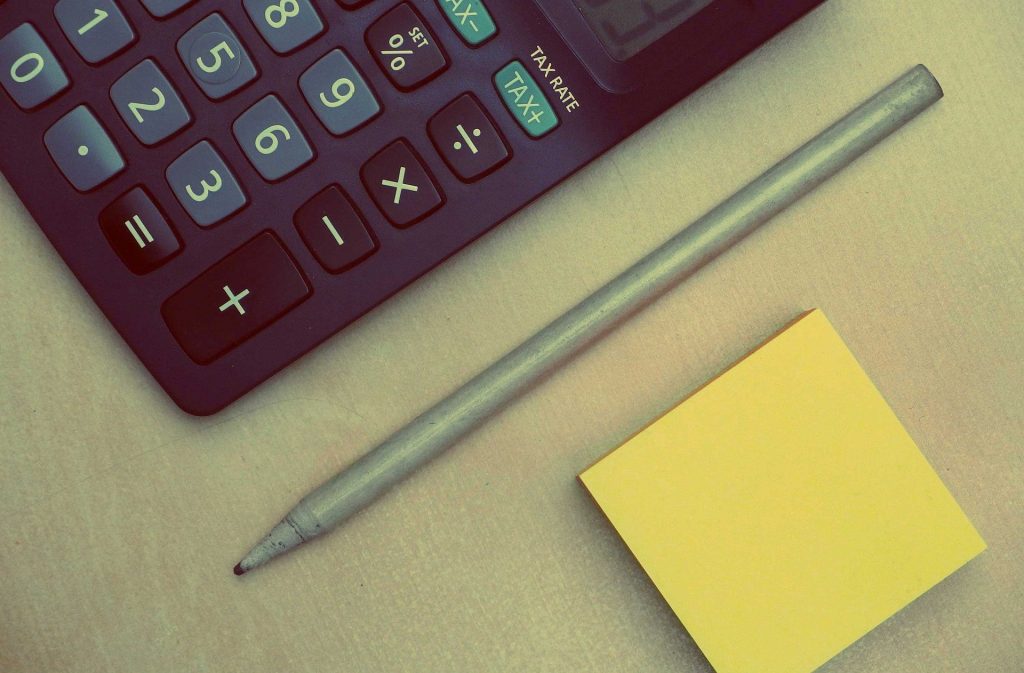 Calculator, pen and post-it notes